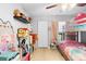 Bright bedroom featuring a bunk bed, ceiling fan, and charming Hello Kitty themed decor at 1950 Summer Club Dr # 200, Oviedo, FL 32765