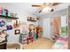 bedroom filled with toys, laminate flooring, a ceiling fan and a large window at 1950 Summer Club Dr # 200, Oviedo, FL 32765