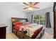Bright bedroom features a ceiling fan, large window and a wooden bed frame at 1950 Summer Club Dr # 200, Oviedo, FL 32765