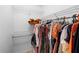 A walk-in closet features metal racks for hanging and storing clothes and personal items at 1950 Summer Club Dr # 200, Oviedo, FL 32765