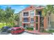 Condo exterior features balconies, parking, and mature landscaping at 1950 Summer Club Dr # 200, Oviedo, FL 32765