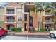 Condo exterior features balconies, stairwell, and colorful facade at 1950 Summer Club Dr # 200, Oviedo, FL 32765