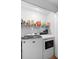 A laundry room features a modern washer and dryer and shelving for storage at 1950 Summer Club Dr # 200, Oviedo, FL 32765