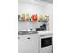 A laundry room features a modern washer and dryer and shelving for storage at 1950 Summer Club Dr # 200, Oviedo, FL 32765