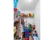Spacious walk-in closet featuring clothing rack and shelving, filled with clothes, toys and storage boxes at 1950 Summer Club Dr # 200, Oviedo, FL 32765