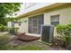 View of enclosed back patio with sliding screen door and tan stucco exterior wall at 1967 Beacon Bay Ct, Apopka, FL 32712
