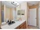 Bathroom featuring a double vanity, large mirror, and a separate water closet at 1967 Beacon Bay Ct, Apopka, FL 32712