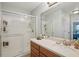 Bathroom featuring a glass-enclosed shower, large mirror, and a vanity with ample storage at 1967 Beacon Bay Ct, Apopka, FL 32712