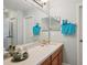 Bright bathroom featuring a long counter and mirror with stylish decor and fresh, neatly arranged blue towels at 1967 Beacon Bay Ct, Apopka, FL 32712