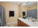 Neat bathroom featuring a neutral tone with tiled floor, a mirror and a shower with a curtain at 1967 Beacon Bay Ct, Apopka, FL 32712