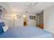 Cozy bedroom with views to the en-suite bathroom, comfortable blue bedding, and carpeted floors at 1967 Beacon Bay Ct, Apopka, FL 32712