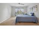 Comfortable bedroom with a blue quilted bedspread, ceiling fan, and bright natural light at 1967 Beacon Bay Ct, Apopka, FL 32712