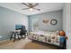 Comfortable bedroom with modern desk, fan, plush carpet and a decorative wall art at 1967 Beacon Bay Ct, Apopka, FL 32712