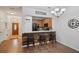 Cozy dining area featuring a wood accent wall, eat-in counter, and seamless flow into the kitchen at 1967 Beacon Bay Ct, Apopka, FL 32712