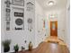 Welcoming foyer with hardwood floors, decorative wall art, and a glass-paneled front door at 1967 Beacon Bay Ct, Apopka, FL 32712