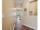 Hallway with wood floors leading to a bedroom, enhanced by a decorative dream catcher at 1967 Beacon Bay Ct, Apopka, FL 32712