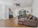 Inviting living room with wood floors, a comfortable sectional, and ample natural light at 1967 Beacon Bay Ct, Apopka, FL 32712