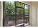 Covered patio with tiled floor, screened windows and lush greenery providing serene privacy at 1967 Beacon Bay Ct, Apopka, FL 32712
