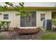 Back patio with an air conditioner surrounded by landscaping, offering private outdoor space at 1967 Beacon Bay Ct, Apopka, FL 32712