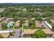 Aerial view of a community with a pool and tennis courts surrounded by mature trees at 200 St Andrews Blvd # 911, Winter Park, FL 32792