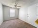 Functional bedroom featuring a window, ceiling fan, and a convenient door for easy access at 200 St Andrews Blvd # 911, Winter Park, FL 32792
