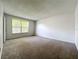 Bedroom featuring neutral walls and carpet with a window that provides plenty of natural light at 200 St Andrews Blvd # 911, Winter Park, FL 32792