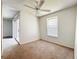 Bright bedroom featuring a ceiling fan, window, and sliding glass doors for natural light and ventilation at 200 St Andrews Blvd # 911, Winter Park, FL 32792