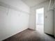Walk-in closet featuring shelving and carpeted floors, providing ample storage space at 200 St Andrews Blvd # 911, Winter Park, FL 32792