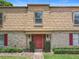 Charming townhome entrance featuring well-kept landscaping and a brick facade at 200 St Andrews Blvd # 911, Winter Park, FL 32792