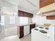 The kitchen boasts an open layout, white appliances, and ample counter space for cooking prep at 200 St Andrews Blvd # 911, Winter Park, FL 32792