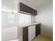 The kitchen has an island that doubles as a breakfast bar, white appliances, and views to the living space at 200 St Andrews Blvd # 911, Winter Park, FL 32792