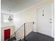 Carpeted landing on upper level with chandelier lighting and secure front door at 200 St Andrews Blvd # 911, Winter Park, FL 32792