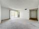 Open living area with sliding doors to the balcony and a hallway leading to other parts of the home at 200 St Andrews Blvd # 911, Winter Park, FL 32792