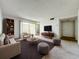 Bright living room featuring neutral tones, a large window, and modern furnishings at 200 St Andrews Blvd # 911, Winter Park, FL 32792
