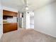 Cozy living room with a ceiling fan, seamlessly connecting to the kitchen area with ample counter space at 200 St Andrews Blvd # 911, Winter Park, FL 32792