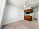 Comfortable living room with a view of the kitchen, featuring essential appliances and plenty of natural light at 200 St Andrews Blvd # 911, Winter Park, FL 32792