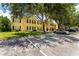 Exterior view of building with large mature shade trees, parking, and green lawn space at 2041 Dixie Belle Dr # 2041C, Orlando, FL 32812