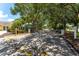 View of the community entrance gate surrounded by beautiful trees and landscaping at 2041 Dixie Belle Dr # 2041C, Orlando, FL 32812