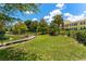 Manicured green space and landscaping area in community with walking paths and sitting areas at 2041 Dixie Belle Dr # 2041C, Orlando, FL 32812