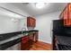 Kitchen with dark granite countertops, stainless steel refrigerator and wood flooring at 2041 Dixie Belle Dr # 2041C, Orlando, FL 32812
