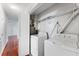Bright laundry room with full-size washer and dryer along with shelves for additional storage at 2041 Dixie Belle Dr # 2041C, Orlando, FL 32812