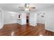 Open-concept living space with hardwood floors, ceiling fan, and a view into the kitchen at 2041 Dixie Belle Dr # 2041C, Orlando, FL 32812