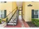 View of outdoor stairwell leading to the upper units of the yellow apartment building at 2041 Dixie Belle Dr # 2041C, Orlando, FL 32812