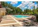 Relaxing community swimming pool with comfortable lounge chairs, perfect for sunbathing on the expansive brick deck at 2041 Dixie Belle Dr # 2041C, Orlando, FL 32812