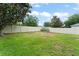 Wide view of fenced backyard with grass and mature trees, creating a private oasis at 2042 Hayfield Way, Apopka, FL 32712