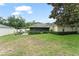 Lush backyard showcases screened lanai, patio area, and verdant landscaping at 2042 Hayfield Way, Apopka, FL 32712