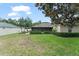 Lush backyard showcases screened lanai, patio area, and verdant landscaping at 2042 Hayfield Way, Apopka, FL 32712