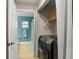 Laundry room area with view of blue toned bathroom at 2042 Hayfield Way, Apopka, FL 32712