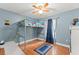 Bedroom with high bed, ceiling fan, and blue walls at 2042 Hayfield Way, Apopka, FL 32712