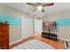 Bedroom with a ceiling fan, hardwood floors, and a television set, offering space and comfort at 2042 Hayfield Way, Apopka, FL 32712